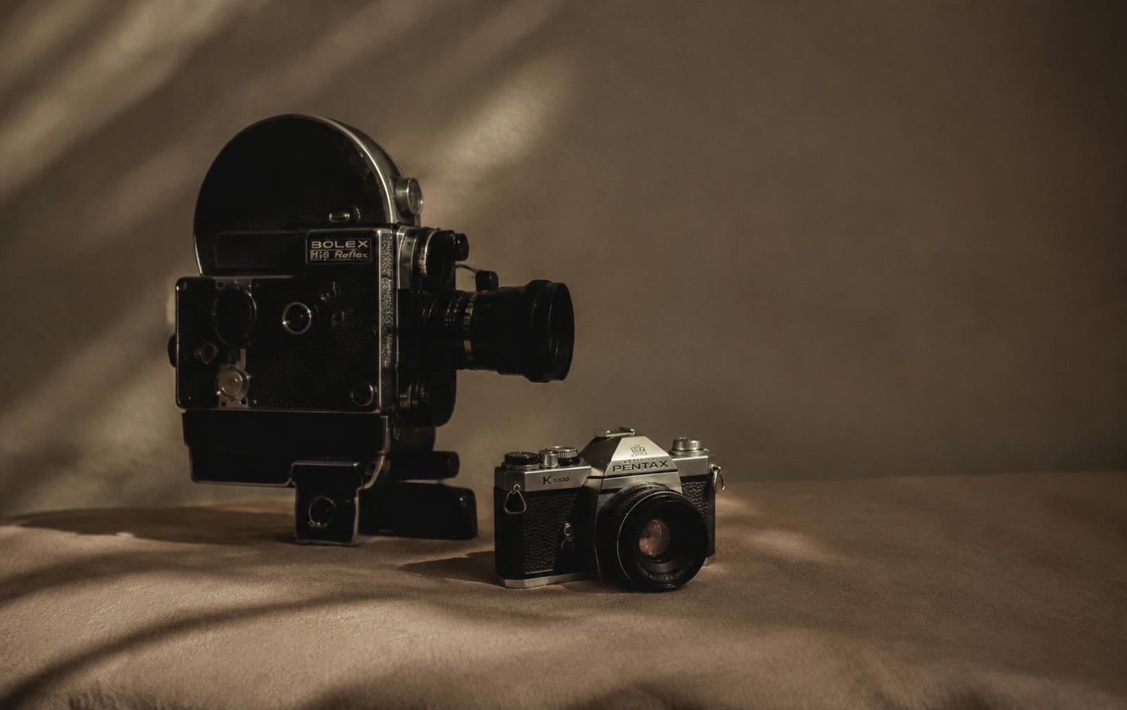 Vintage cinema camera beside a film camera